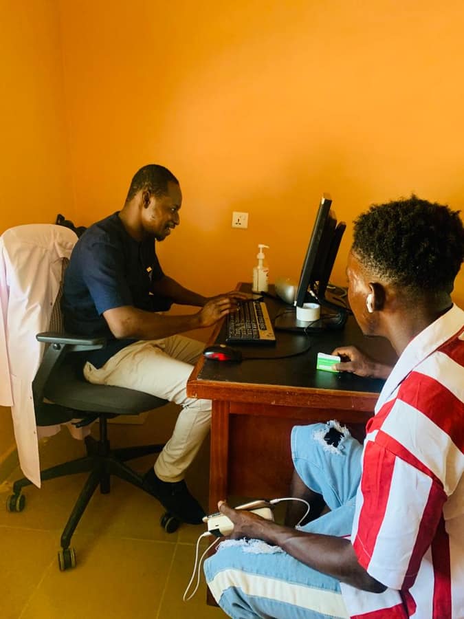 Clinician reviewing a patient's record during a consultation at Menesto Medical Center