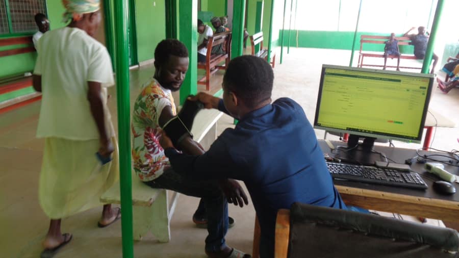 Staff taking a patient's blood pressure during OPD registration at Menesto Medical Center